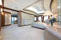 Luxurious yacht interior with elegant design, featuring a spacious bedroom and modern decor.