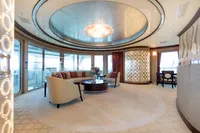 Luxurious yacht interior with elegant seating, chandelier, and panoramic windows, Oceanco Custom 2001.