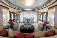 Luxurious yacht interior with elegant seating, floral centerpiece, and modern design elements, Oceanco Custom 2001.