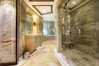 Luxurious yacht bathroom with marble decor, glass shower, and elegant lighting, Oceanco Custom 2001.