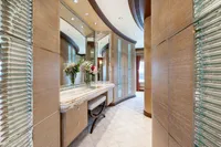 Luxurious yacht interior with elegant vanity, mirrors, and floral arrangement, Oceanco Custom 2001 model.