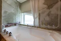 Luxurious marble bathtub with window view on Oceanco Custom yacht, 2001 model.
