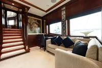 Luxurious yacht interior with elegant wood paneling, plush seating, and decorative artwork, Oceanco Custom 2001.
