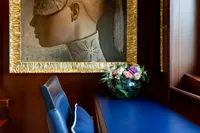 Luxurious yacht interior with elegant artwork and floral arrangement, Oceanco Custom 2001.