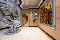Luxurious yacht interior with elegant decor, spiral staircase, and ornate artwork, Oceanco Custom 2001.