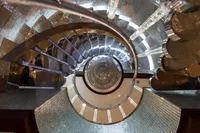 Spiral staircase with reflective surfaces on a 2001 Oceanco Custom yacht.