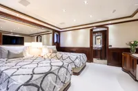 Luxurious yacht bedroom with twin beds, elegant decor, and ambient lighting, Oceanco Custom 2001.