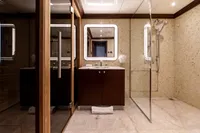 Luxurious yacht bathroom with modern fixtures, glass shower, and elegant wood cabinetry, Oceanco Custom 2001.