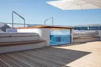Luxurious Oceanco Custom yacht deck with seating, wooden flooring, and pool, 2001 model.