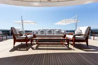 Luxurious Oceanco Custom yacht deck with elegant seating and umbrellas, 2001 model.