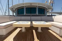 Luxury yacht deck with cushioned seating and decorative tables, Oceanco Custom 2001 model.