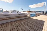 Luxurious Oceanco Custom yacht deck with sun loungers and parasols, 2001 model.