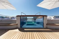 Luxurious yacht deck with a glass-walled pool, Oceanco Custom 2001 model.