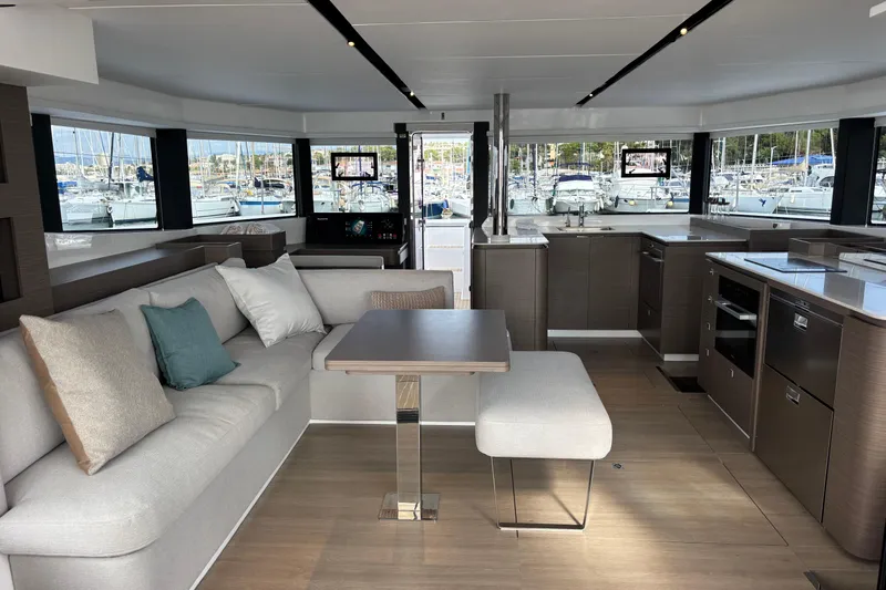 Faste Yacht Photos Pics Luxurious interior of 2025 Leopard 52 yacht with modern kitchen and comfortable seating.