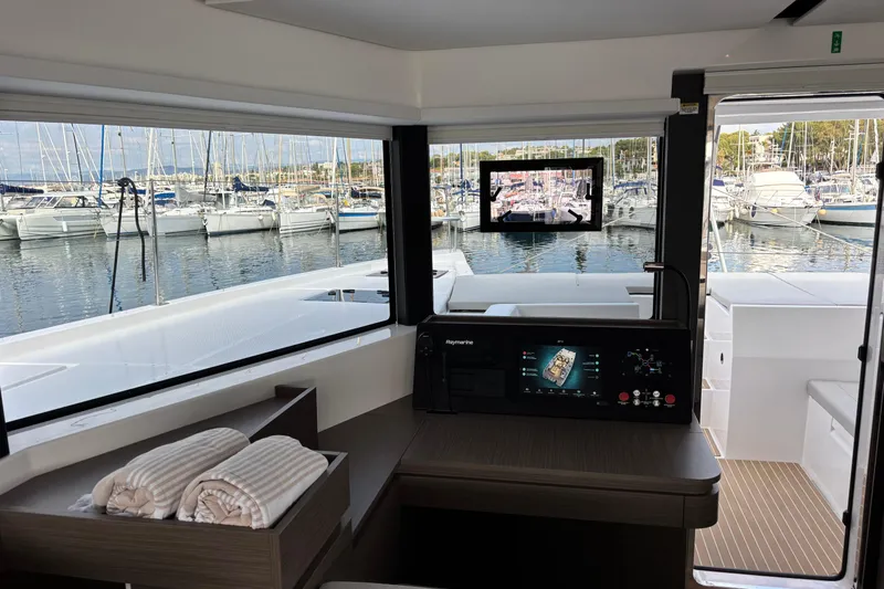 Faste Yacht Photos Pics Interior view of 2025 Leopard 52 yacht with marina backdrop and navigation system.