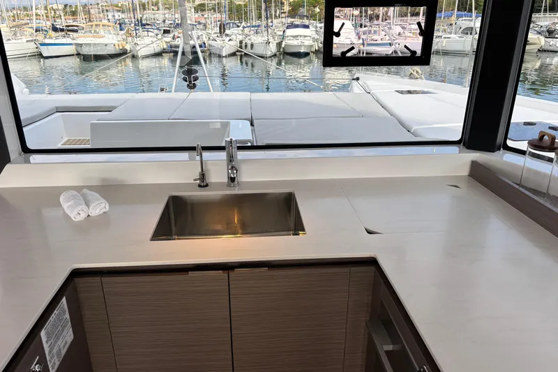 Faste Yacht Photos Pics Modern kitchen interior on 2025 Leopard 52 yacht with marina view.