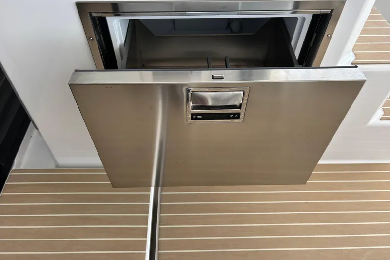 Faste Yacht Photos Pics Stainless steel drawer on 2025 Leopard 52 yacht, open on wooden deck.
