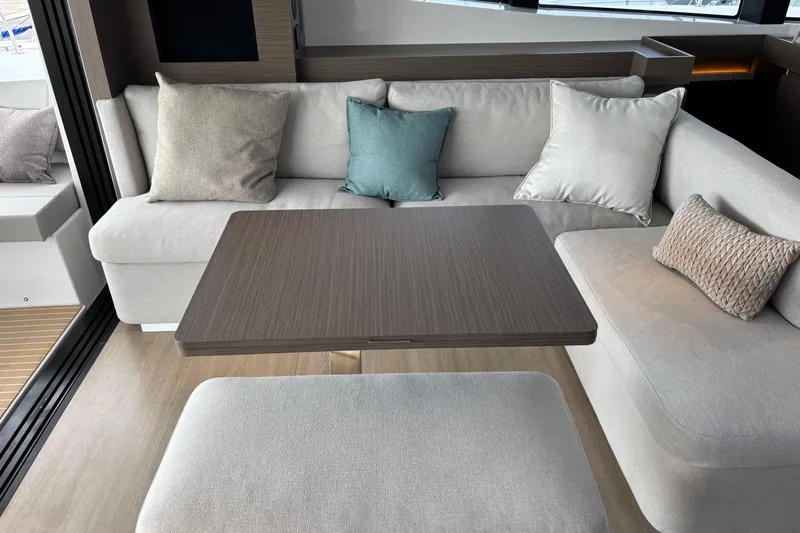 Faste Yacht Photos Pics Modern interior of 2025 Leopard 52 yacht with cozy seating and elegant table.