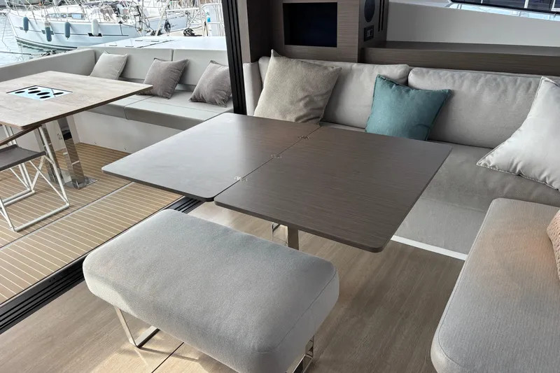 Faste Yacht Photos Pics Luxurious interior of 2025 Leopard 52 yacht with modern seating and dining area.