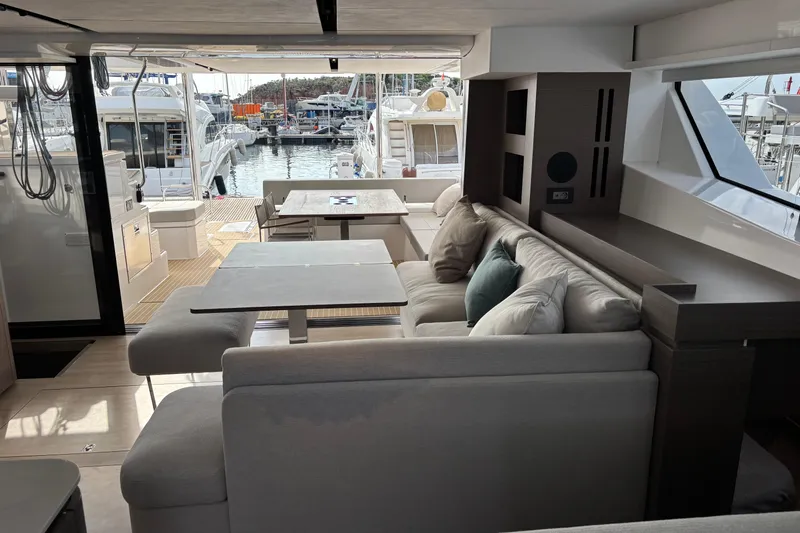 Faste Yacht Photos Pics Luxurious interior of 2025 Leopard 52 yacht with modern seating and marina view.