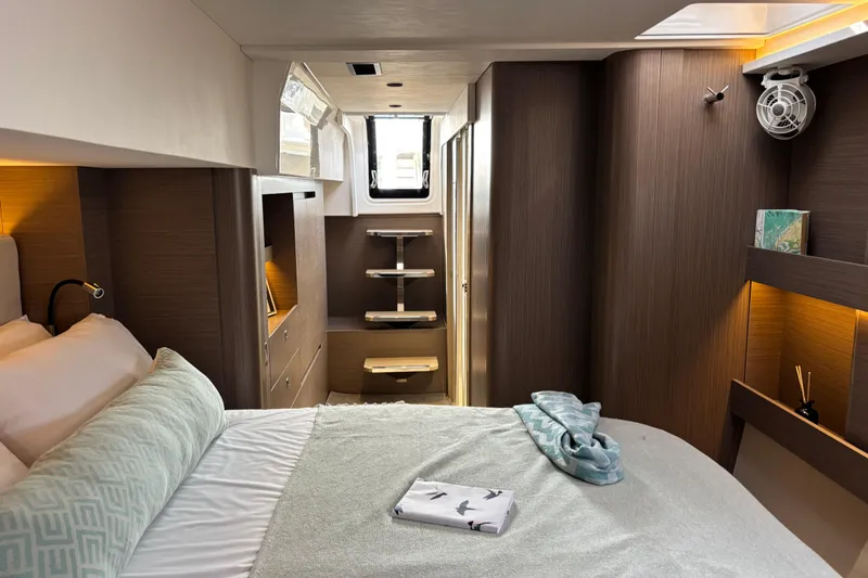 Faste Yacht Photos Pics Luxurious cabin interior of 2025 Leopard 52 yacht with modern design and cozy bedding.