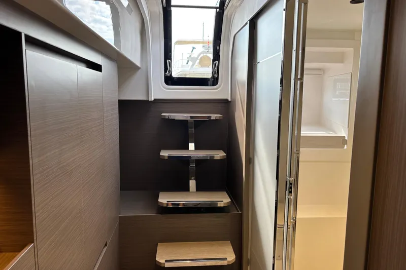 Faste Yacht Photos Pics Interior of 2025 Leopard 52 yacht with modern wooden cabinetry and sleek staircase.