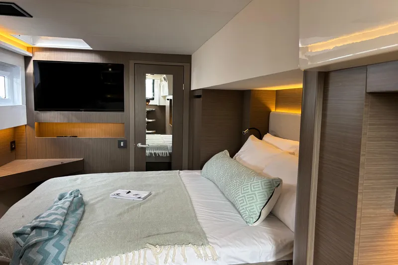 Faste Yacht Photos Pics Luxurious bedroom interior of 2025 Leopard 52 yacht with modern decor and amenities.