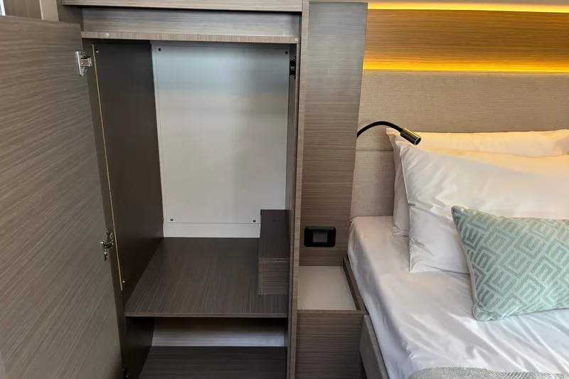Faste Yacht Photos Pics Empty wardrobe and bed in Leopard 52 yacht, 2025 model, with modern interior design.