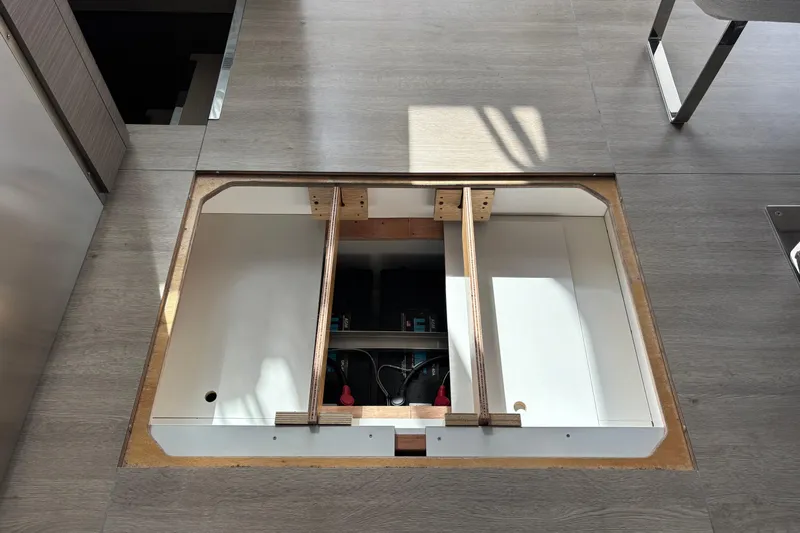 Faste Yacht Photos Pics Open floor compartment in 2025 Leopard 52 yacht, revealing storage space and equipment.