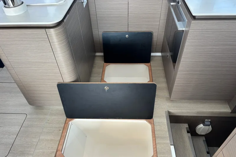 Faste Yacht Photos Pics Open storage compartments in the kitchen area of a 2025 Leopard 52 yacht.