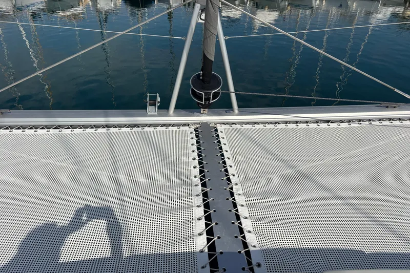 Faste Yacht Photos Pics Trampoline netting on 2025 Leopard 52 catamaran with marina reflection in water.