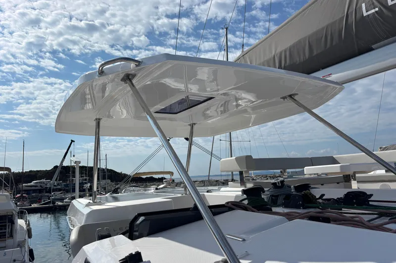 Faste Yacht Photos Pics 2025 Leopard 52 yacht with sleek design, docked under a partly cloudy sky.