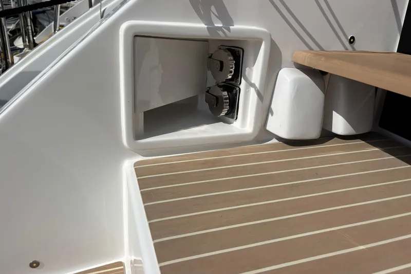 Faste Yacht Photos Pics 2025 Leopard 52 yacht deck with storage compartment and wooden flooring.