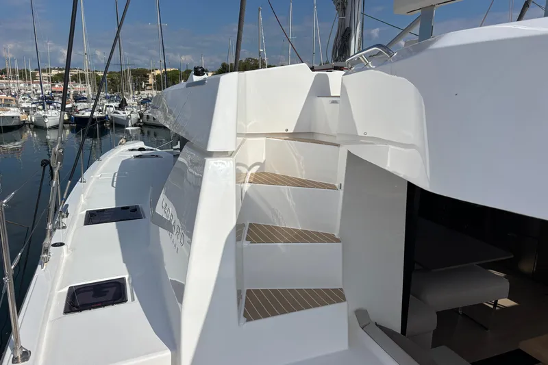 Faste Yacht Photos Pics 2025 Leopard 52 yacht with sleek design, docked in a marina under clear skies.