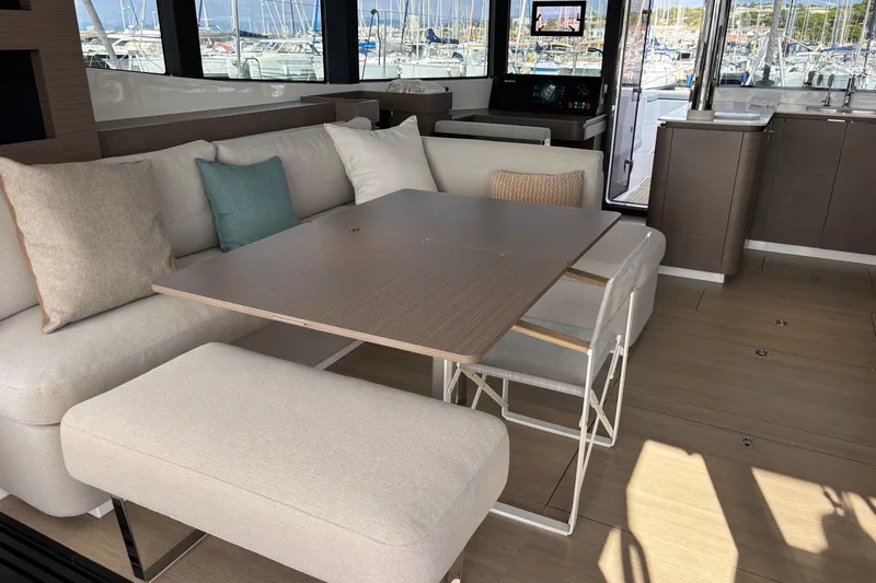 Faste Yacht Photos Pics Luxurious interior of 2025 Leopard 52 yacht with modern seating and dining area.