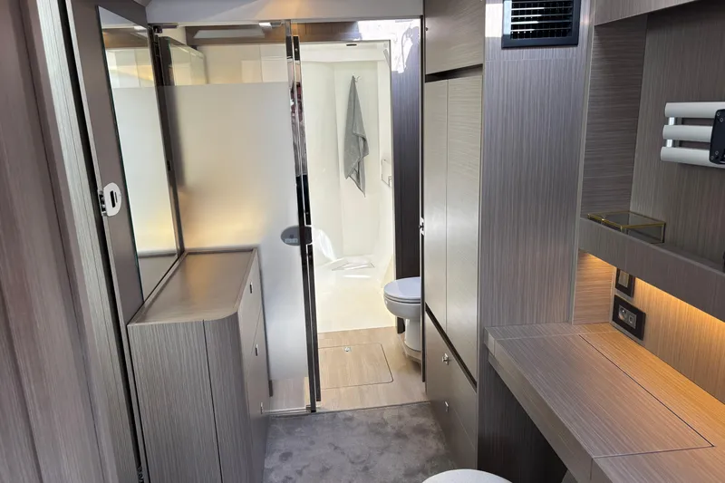 Faste Yacht Photos Pics Modern interior of 2025 Leopard 52 yacht featuring sleek bathroom and stylish cabinetry.
