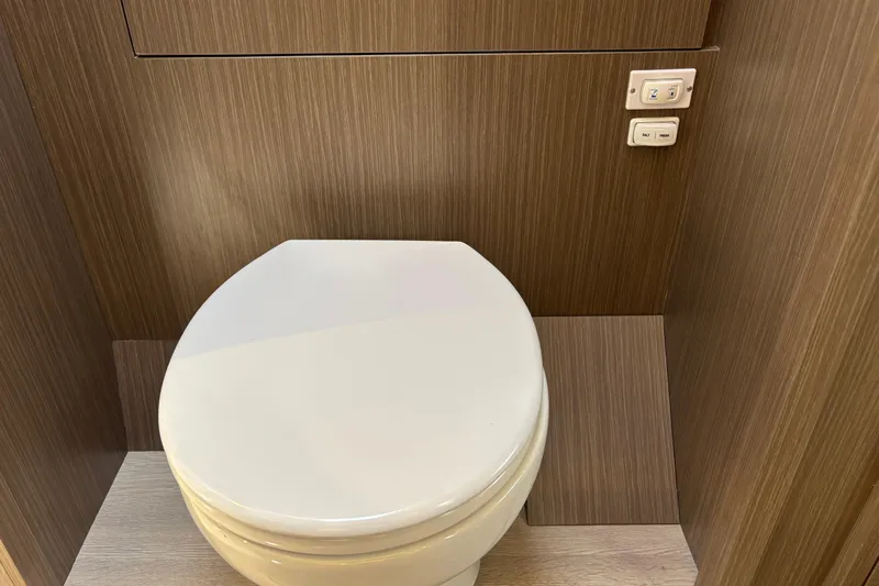 Faste Yacht Photos Pics Modern bathroom on Leopard 52 yacht, featuring sleek toilet design, 2025 model.