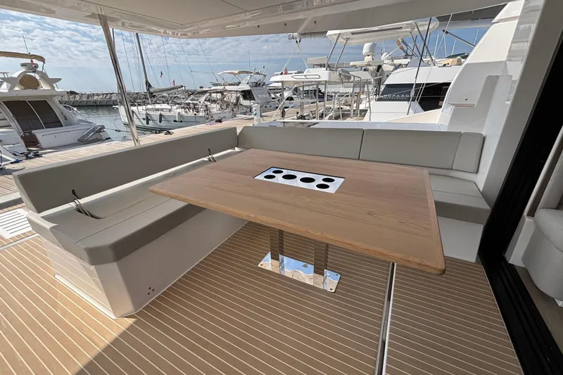 Faste Yacht Photos Pics Luxurious Leopard 52 yacht deck with seating and wooden table, 2025 model.