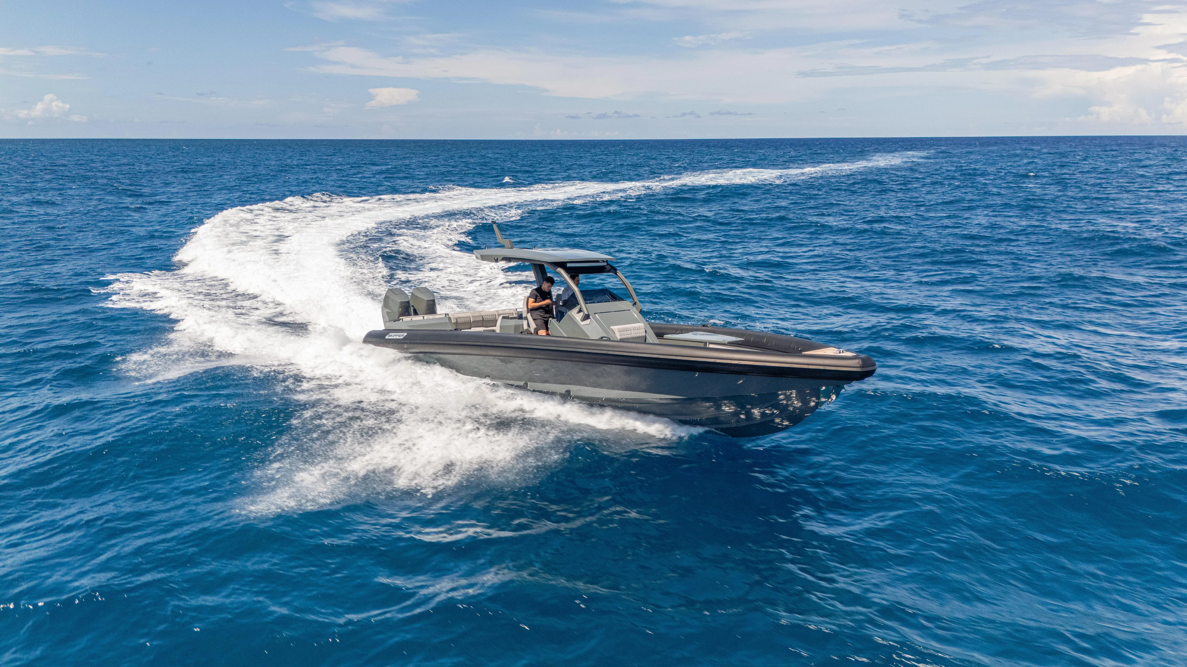 Skipper 38 Twin Mercury 400 Verado - Sunbed Ed. Yacht Photos Pics 2025 Skipper-BSK 38 boat cruising on open blue ocean under clear sky.