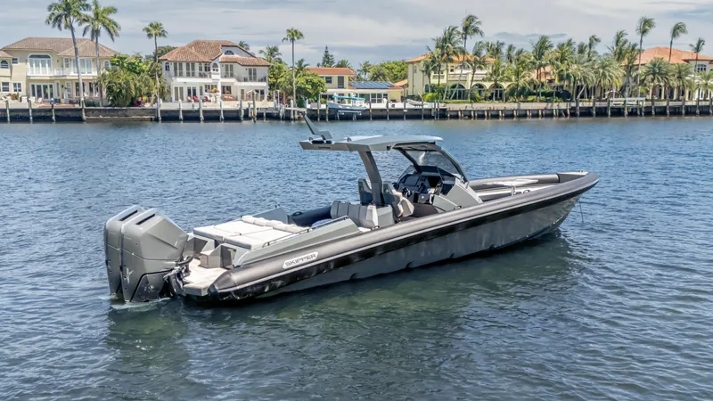 Skipper 38 Twin Mercury 400 Verado - Sunbed Ed. Yacht Photos Pics 2025 Skipper-BSK 38 boat on water near luxury waterfront homes.