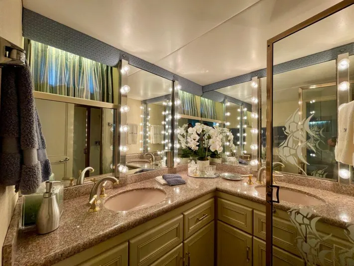  Yacht Photos Pics Luxurious bathroom in 1989 Pilothouse West Bay yacht with dual sinks and elegant lighting.