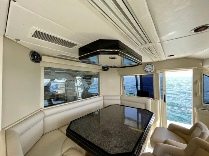  Yacht Photos Pics Luxurious 1989 Pilothouse West Bay interior with ocean view, featuring elegant seating and modern design.