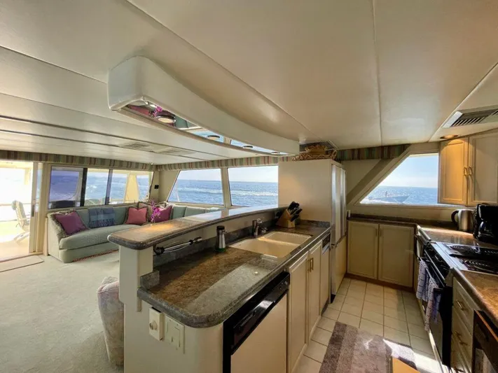  Yacht Photos Pics Luxurious 1989 Pilothouse West Bay yacht interior with modern kitchen and ocean view.