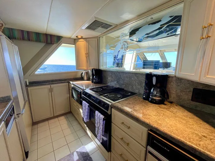  Yacht Photos Pics Luxurious 1989 Pilothouse West Bay yacht kitchen with ocean view, modern appliances, and ample counter space.