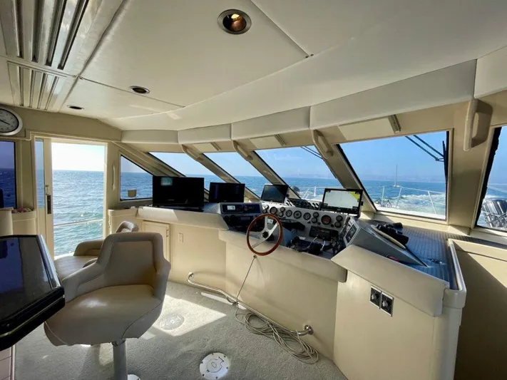  Yacht Photos Pics Pilothouse West Bay 1989 interior with steering wheel, navigation equipment, and ocean view.