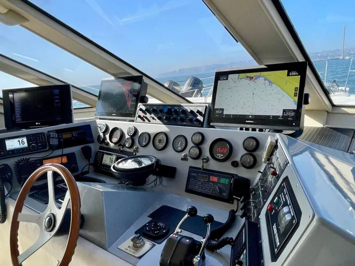  Yacht Photos Pics Pilothouse West Bay 1989 yacht cockpit with navigation screens and steering wheel, overlooking ocean.