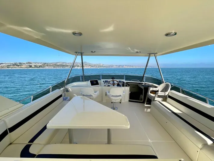  Yacht Photos Pics 1989 Pilothouse West Bay yacht deck with seating, table, and ocean view.