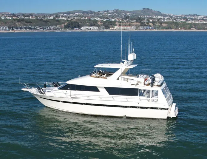  Yacht Photos Pics 1989 Pilothouse West Bay yacht cruising on calm waters near a coastal city.