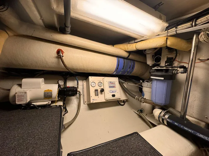 After Midnight Yacht Photos Pics Engine room of 1994 Knight & Carver Lux SF yacht with control panel and piping.