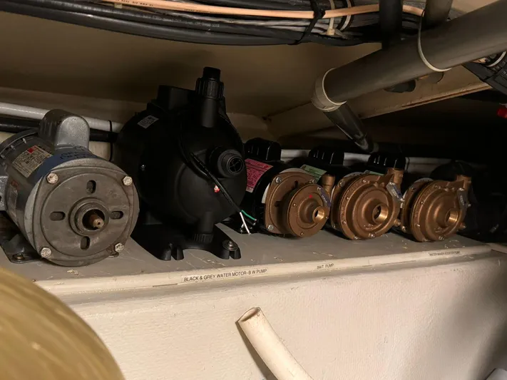 After Midnight Yacht Photos Pics Engine room components of a 1994 Knight & Carver Lux SF yacht, featuring various pumps and motors.